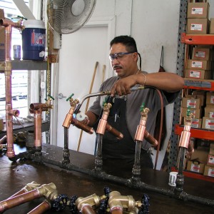 Can Am plumbing tech preparing kits at the warehouse